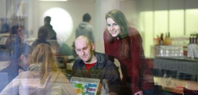 People joined around a laptop